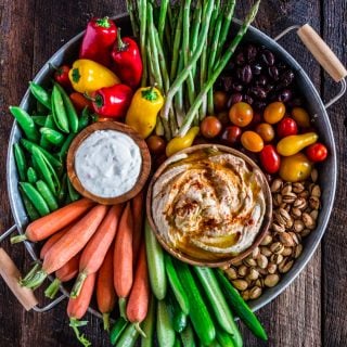 How to Assemble a Crudité Platter | www.oliviascuisine.com | Learn how to set up a Crudité Platter that your guests will actually enjoy, filled with fresh and seasonal veggies and a few delicious dips, olives and nuts. Follow this quick guide and I guarantee you will find even the pickiest of eaters hanging around this awesome vegetable tray! (Recipe and photos by @oliviascuisine)