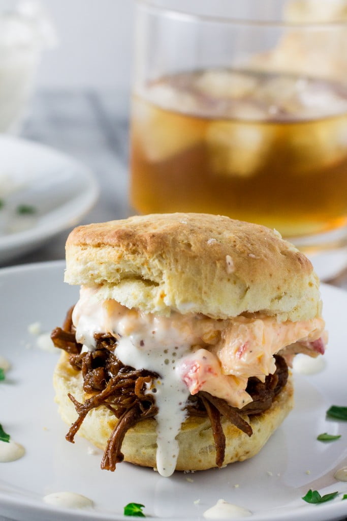 White BBQ Brisket Sandwiches | www.oliviascuisine.com | Eat like a Southerner with these delicious sandwiches made with pulled brisket, white BBQ sauce, pimento cheese in homemade biscuits!