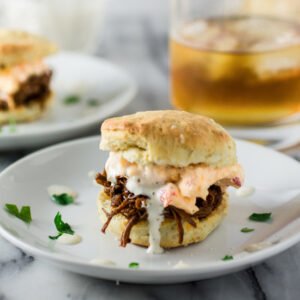 White BBQ Brisket Sandwiches | www.oliviascuisine.com | Eat like a Southerner with these delicious sandwiches made with pulled brisket, white BBQ sauce, pimento cheese in homemade biscuits!