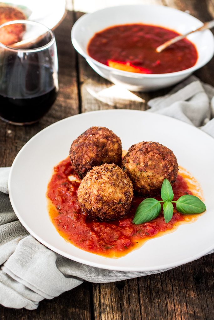 Arancini Di Riso with Balsamic Vinegar and Caramelized Onions Marinara Sauce | www.oliviascuisine.com | These risotto balls stuffed with cheese are an easy and delicious Italian antipasto! The recipe includes a basic parmesan risotto recipe, but you can absolutely use leftover risotto.
