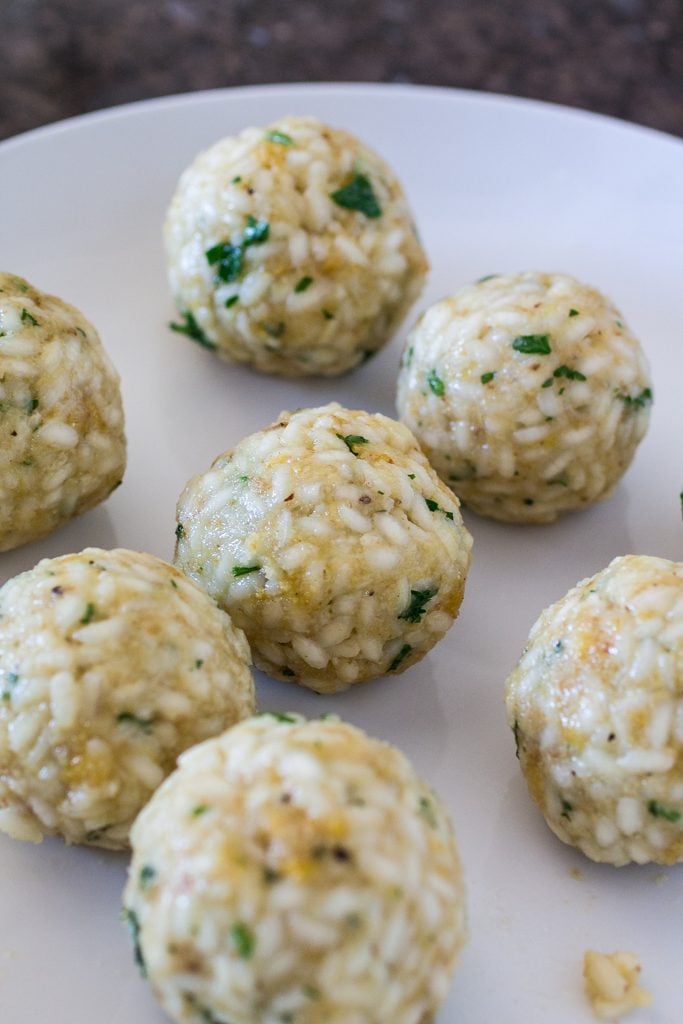 Arancini Di Riso with Balsamic Vinegar and Caramelized Onions Marinara Sauce | www.oliviascuisine.com | These risotto balls stuffed with cheese are an easy and delicious Italian antipasto! The recipe includes a basic parmesan risotto recipe, but you can absolutely use leftover risotto.