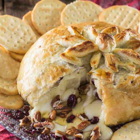 Baked Brie en Croute | www.oliviascuisine.com | A delicious brie cheese covered in puff pastry and filled with honey, cranberries and pecans. Perfect as a Thanksgiving or Christmas appetizer!