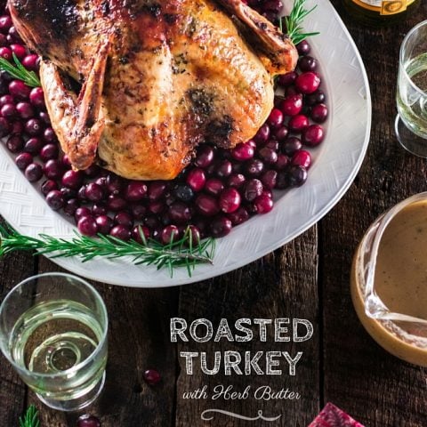 Roasted Turkey with Herb Butter | www.oliviascuisine.com | Looking for a good turkey recipe for Thanksgiving or Christmas? Look no further! This turkey is roasted with a parsley, lemon and garlic butter and covered in bacon (during roasting time) for amazing flavor and juiciness!