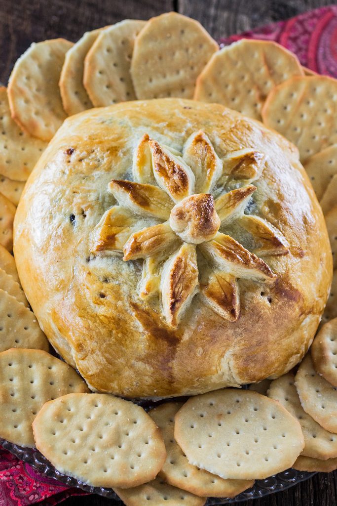 Baked Brie en Croute | www.oliviascuisine.com | A delicious brie cheese covered in puff pastry and filled with honey, cranberries and pecans. Perfect as a Thanksgiving or Christmas appetizer!