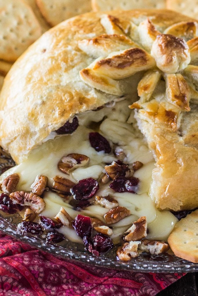 Baked Brie en Croute | www.oliviascuisine.com | A delicious brie cheese covered in puff pastry and filled with honey, cranberries and pecans. Perfect as a Thanksgiving or Christmas appetizer!