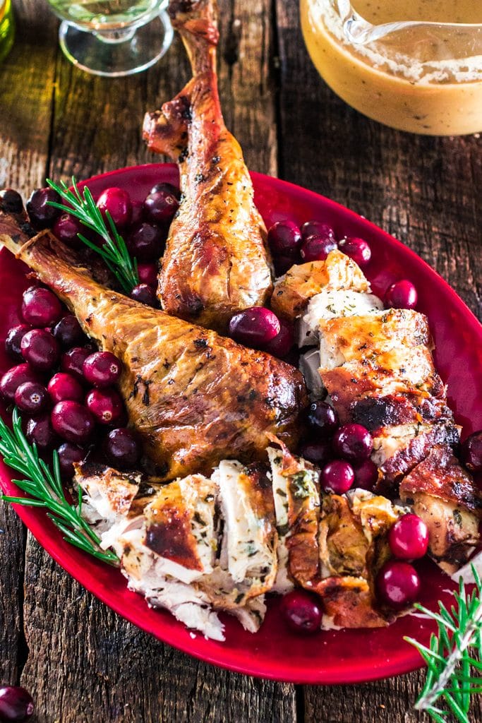 Roasted Turkey with Herb Butter | www.oliviascuisine.com | Looking for a good turkey recipe for Thanksgiving or Christmas? Look no further! This turkey is roasted with a parsley, lemon and garlic butter and covered in bacon (during roasting time) for amazing flavor and juiciness! 