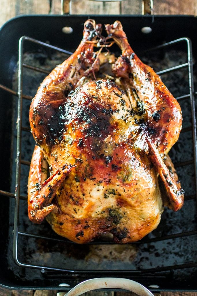 Roasted Turkey with Herb Butter | www.oliviascuisine.com | Looking for a good turkey recipe for Thanksgiving or Christmas? Look no further! This turkey is roasted with a parsley, lemon and garlic butter and covered in bacon (during roasting time) for amazing flavor and juiciness! 