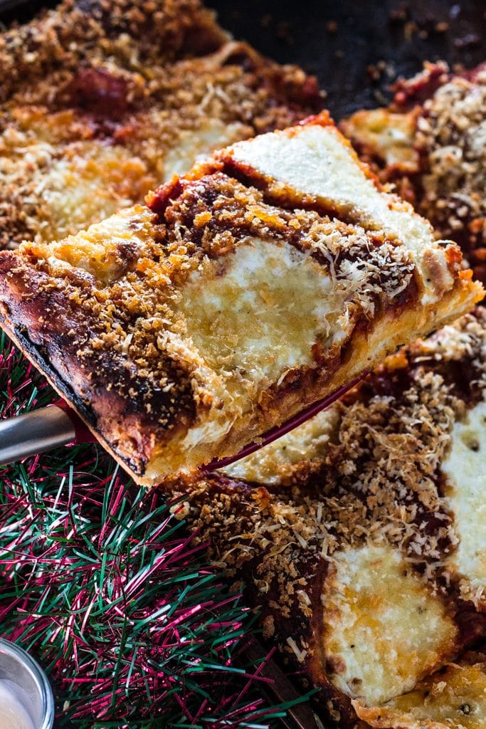 Sfincione (Sicilian Christmas Pizza) | www.oliviascuisine.com | This deep-dish pizza is topped with caramelized onions, breadcrumbs and caciocavallo. It is usually served for Christmas Eve or New Year's Eve in Sicily, but available all year long. #sponsored