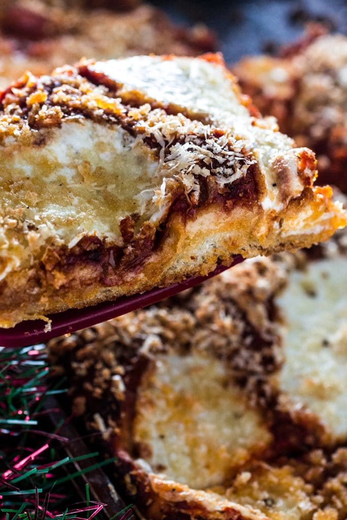 Sfincione (Sicilian Christmas Pizza) | www.oliviascuisine.com | This deep-dish pizza is topped with caramelized onions, breadcrumbs and caciocavallo. It is usually served for Christmas Eve or New Year's Eve in Sicily, but available all year long. #sponsored