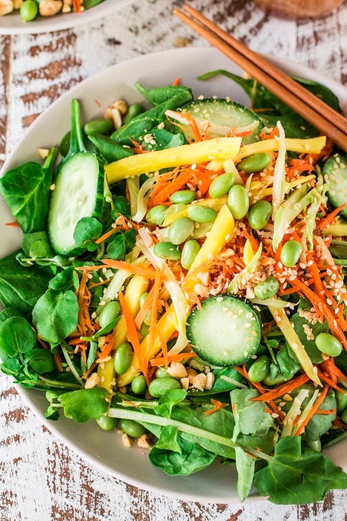 Asian Salad with Sesame Ginger Vinaigrette | www.oliviascuisine.com | Spinach and watercress tossed with carrots, crunchy broccoli stems, mango, cucumbers, edamame, crushed peanuts, sesame seeds and a delicious sesame ginger vinaigrette. Serve with Pagoda egg rolls to make it a meal! #FrozenFromScratch #ad