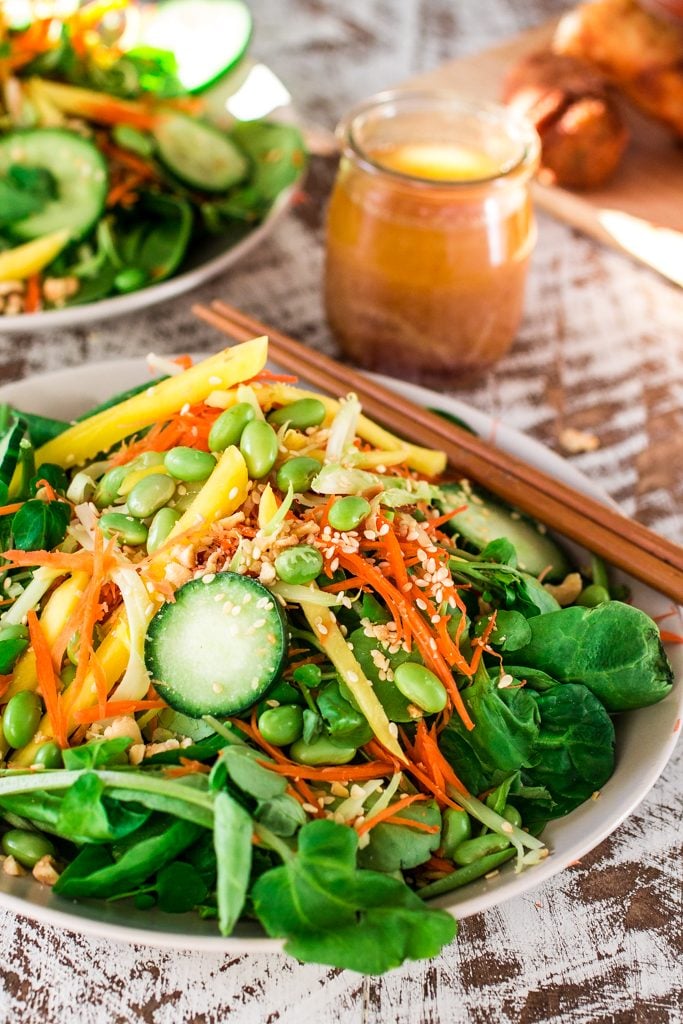 Asian Salad with Sesame Ginger Vinaigrette | www.oliviascuisine.com | Spinach and watercress tossed with carrots, crunchy broccoli stems, mango, cucumbers, edamame, crushed peanuts, sesame seeds and a delicious sesame ginger vinaigrette. Serve with Pagoda egg rolls to make it a meal! #FrozenFromScratch #ad