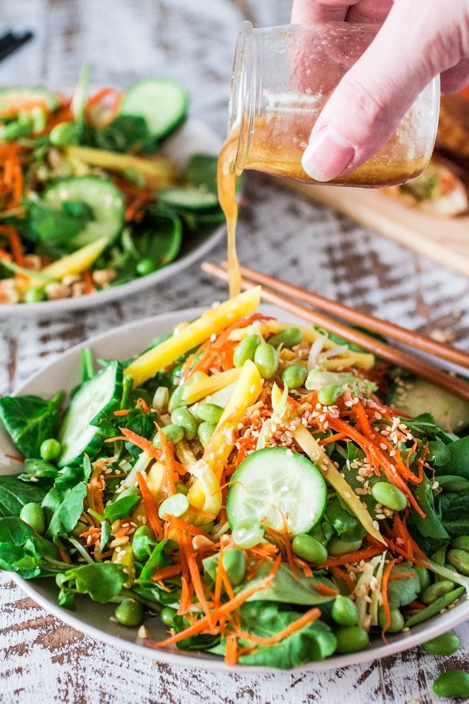 Asian Salad with Sesame Ginger Vinaigrette | www.oliviascuisine.com | Spinach and watercress tossed with carrots, crunchy broccoli stems, mango, cucumbers, edamame, crushed peanuts, sesame seeds and a delicious sesame ginger vinaigrette. Serve with Pagoda egg rolls to make it a meal! #FrozenFromScratch #ad