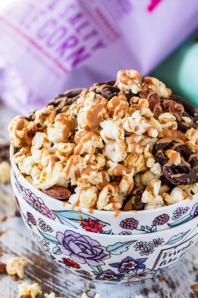 Popcorn Party Mix | www.oliviascuisine.com | Making a popcorn party mix couldn't be easier. Simply toss together some BOOMCHICKAPOP, chocolate covered pretzels and roasted almonds. Oh, and don't forget to drizzle everything with some melted peanut butter! :P #sponsored #BringtheBOOM