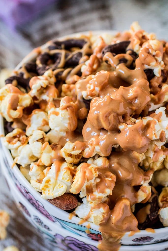 Popcorn Party Mix | www.oliviascuisine.com | Making a popcorn party mix couldn't be easier. Simply toss together some BOOMCHICKAPOP, chocolate covered pretzels and roasted almonds. Oh, and don't forget to drizzle everything with some melted peanut butter! :P #sponsored #BringtheBOOM