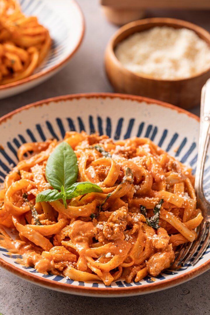 Close-up of creamy fettuccine pasta with spicy Italian sausage and Parmesan cheese