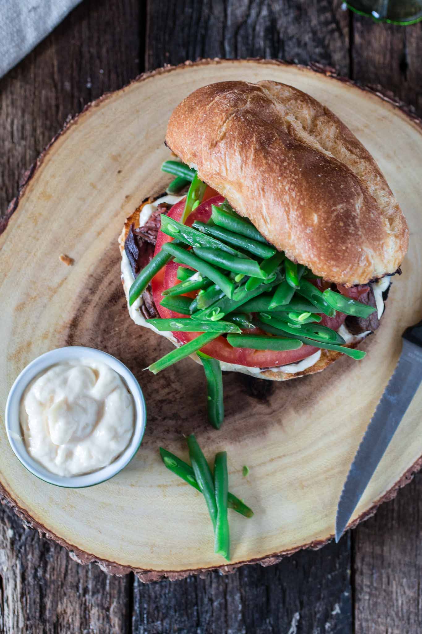 Chacarero (Chilean Steak Sandwich) | www.oliviascuisine.com | This is Chile's national sandwich. It consists of a roll piled high with grilled meat, tomatoes, a dollop of mayo, hot sauce and green beans! (Food styling and photography by Olivia Mesquita.)