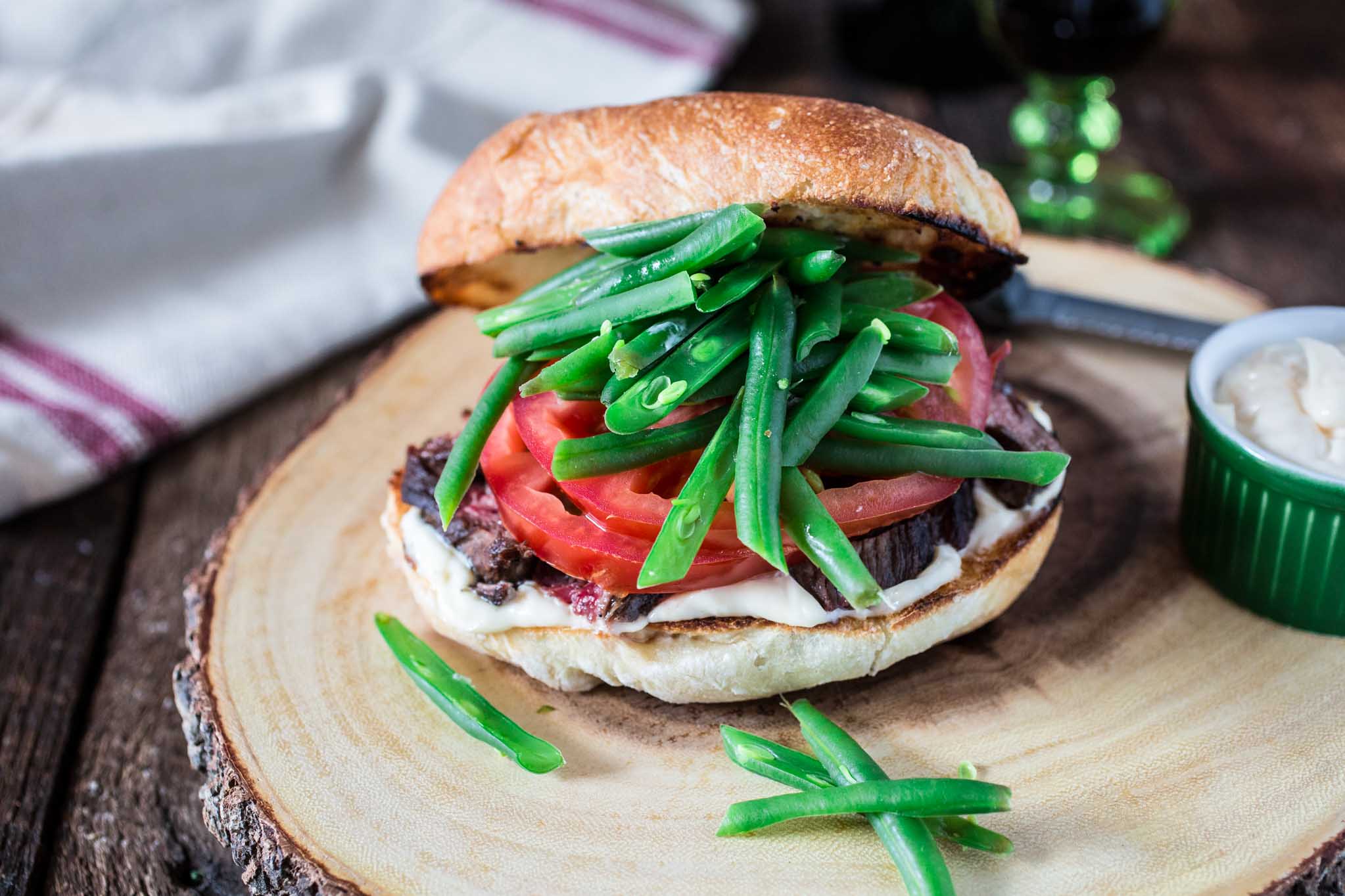Chacarero (Chilean Steak Sandwich) | www.oliviascuisine.com | This is Chile's national sandwich. It consists of a roll piled high with grilled meat, tomatoes, a dollop of mayo, hot sauce and green beans! (Food styling and photography by Olivia Mesquita.)