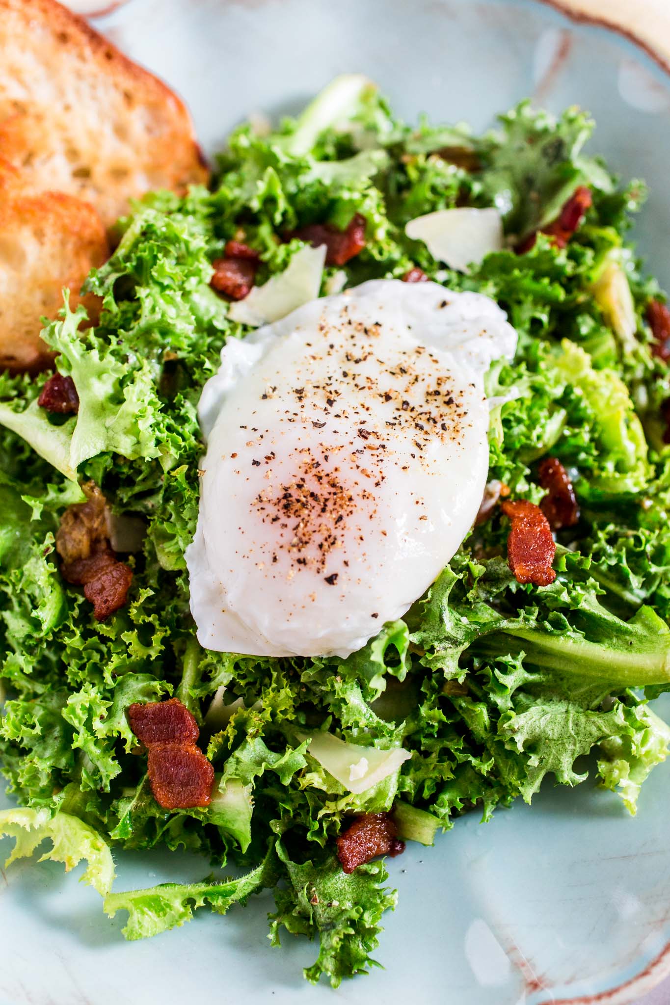 Lyonnaise Salad | www.oliviascuisine.com | This classic French salad, from Lyon, is made with frisée lettuce, bacon, a delicious shallot mustard vinaigrette and a poached egg.