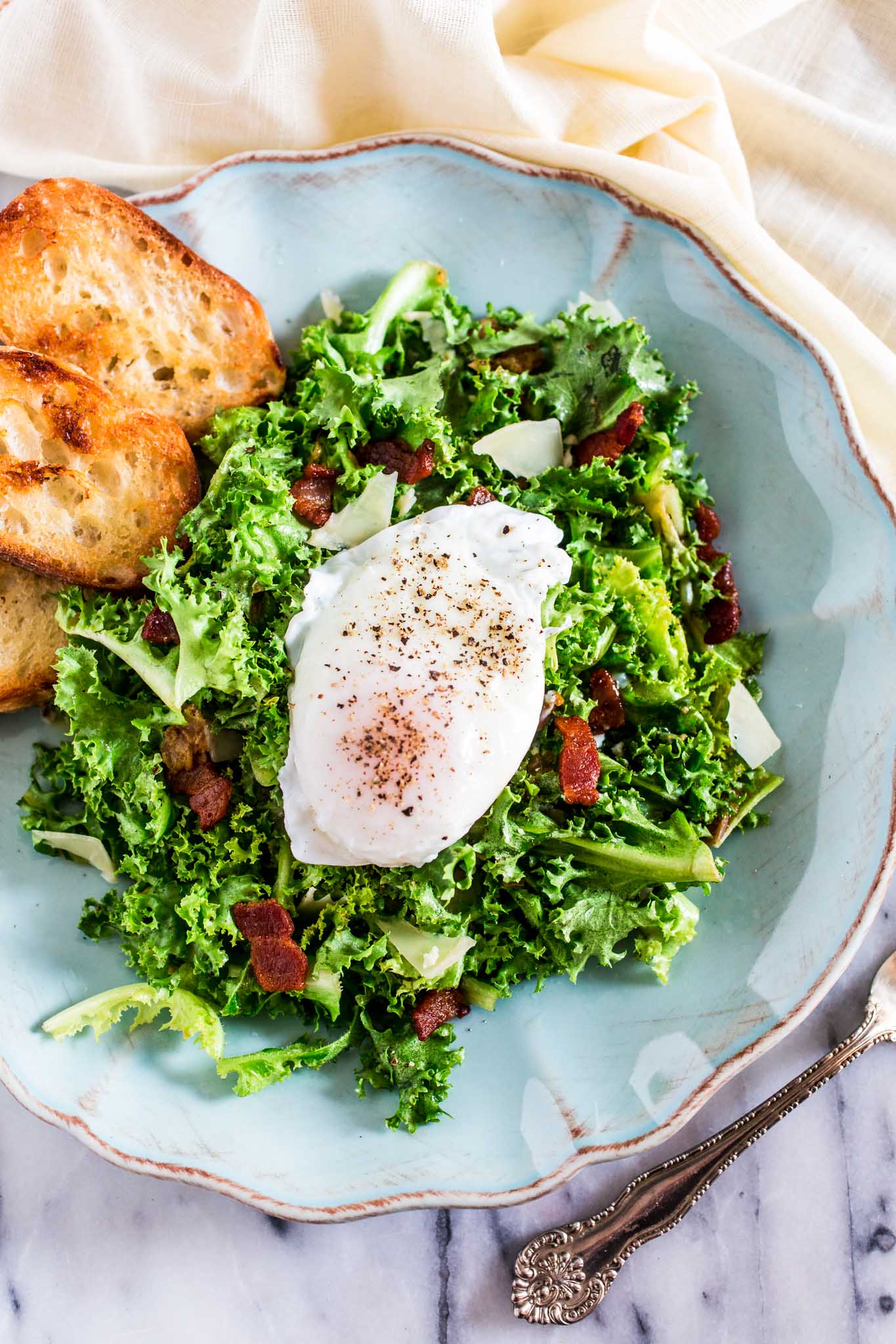 Lyonnaise Salad | www.oliviascuisine.com | This classic French salad, from Lyon, is made with frisée lettuce, bacon, a delicious shallot mustard vinaigrette and a poached egg.