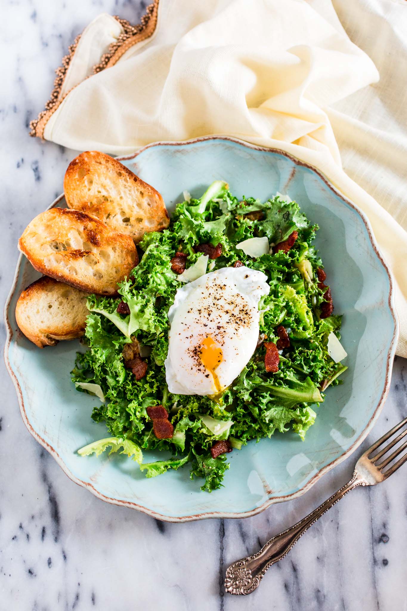 Lyonnaise Salad | www.oliviascuisine.com | This classic French salad, from Lyon, is made with frisée lettuce, bacon, a delicious shallot mustard vinaigrette and a poached egg.