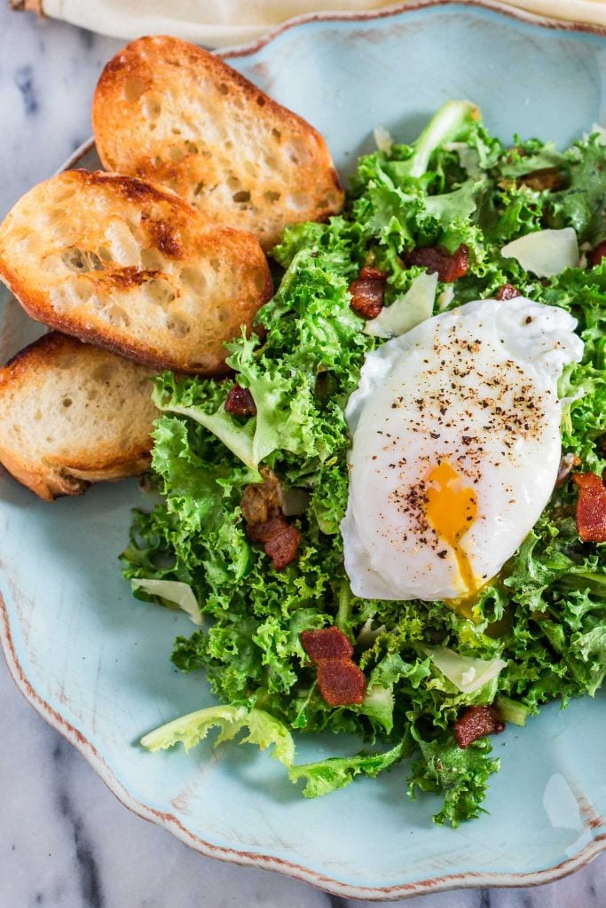 Lyonnaise Salad | www.oliviascuisine.com | This classic French salad, from Lyon, is made with frisée lettuce, bacon, a delicious shallot mustard vinaigrette and a poached egg.