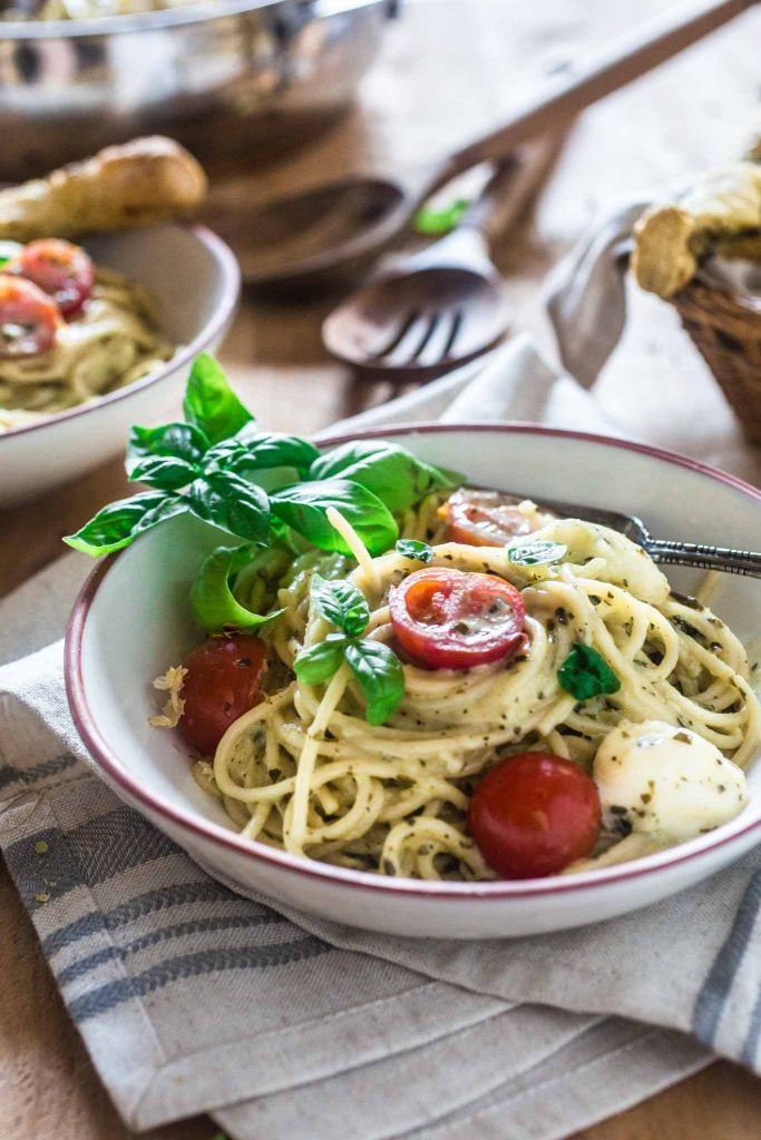 Spaghetti with Pesto Cream Sauce, Fresh Tomatoes and Mozzarella | www.oliviascuisine.com | Who can say "no" to spaghetti tossed in a delicious pesto cream sauce topped with fresh cherry tomatoes and mozzarella balls? Not me! Especially when it's so easy to make and on the table in 15 minutes!