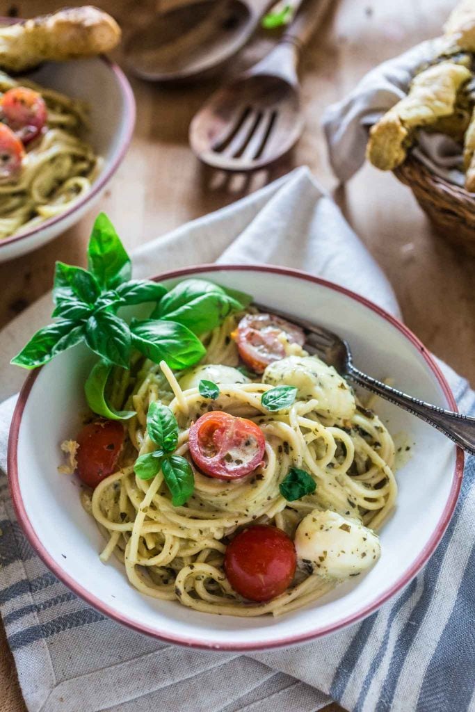 Spaghetti with Pesto Cream Sauce, Fresh Tomatoes and Mozzarella | www.oliviascuisine.com | Who can say "no" to spaghetti tossed in a delicious pesto cream sauce topped with fresh cherry tomatoes and mozzarella balls? Not me! Especially when it's so easy to make and on the table in 15 minutes!