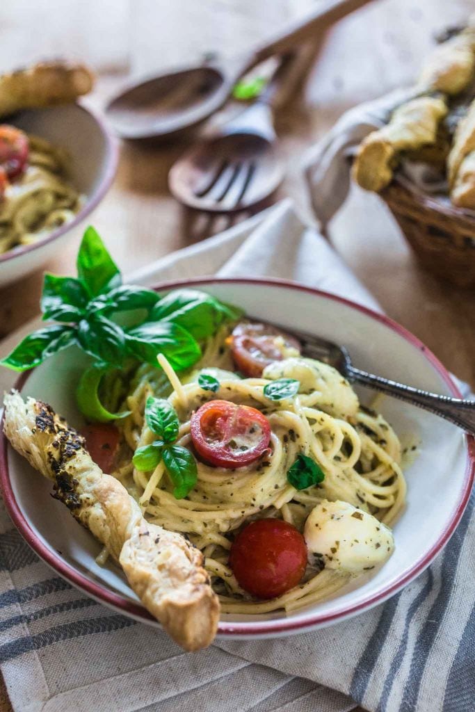 Spaghetti with Pesto Cream Sauce, Fresh Tomatoes and Mozzarella | www.oliviascuisine.com | Who can say "no" to spaghetti tossed in a delicious pesto cream sauce topped with fresh cherry tomatoes and mozzarella balls? Not me! Especially when it's so easy to make and on the table in 15 minutes!