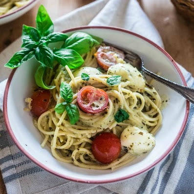Spaghetti with Pesto Cream Sauce, Fresh Tomatoes and Mozzarella | www.oliviascuisine.com | Who can say "no" to spaghetti tossed in a delicious pesto cream sauce topped with fresh cherry tomatoes and mozzarella balls? Not me! Especially when it's so easy to make and on the table in 15 minutes!