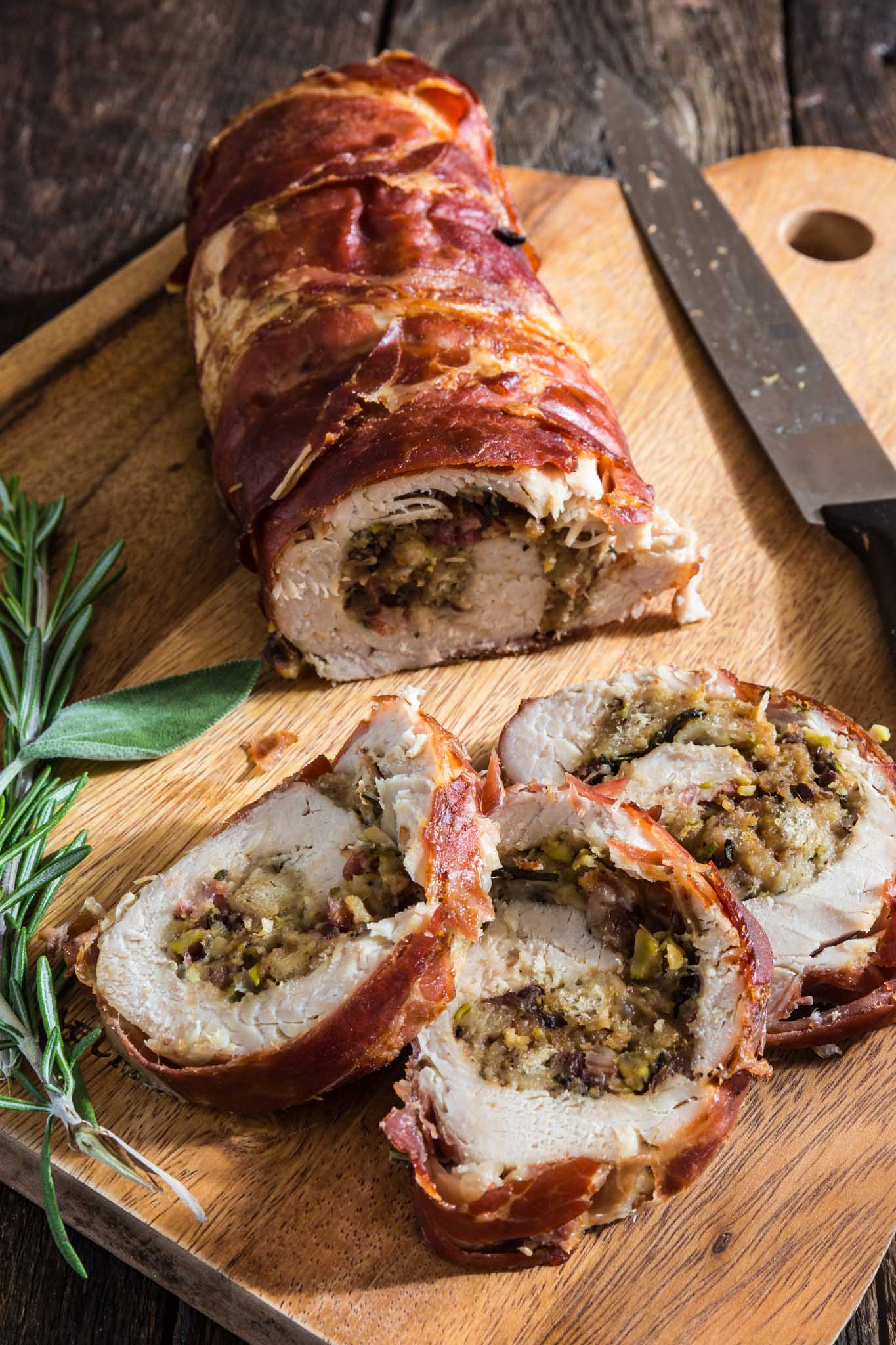 Prosciutto Wrapped Turkey Roulade with Pomegranate-Port Reduction Sauce | www.oliviascuisine.com | No time to roast a whole turkey? Knock the socks off your guests with this simple and quick to assemble turkey roulade. Moist, stuffed with pancetta, pistachio and cranberries, wrapped in Prosciutto di Parma and served with a lip-smacking pomegranate port reduction sauce. One bite and the holidays will never be the same again!