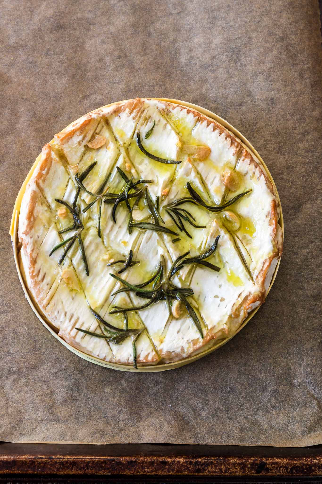 Baked Camembert with Garlic and Rosemary | www.oliviascuisine.com | A gooey and fragrant Baked Camembert is always a must at my dinner parties. This version with garlic and rosemary is one of my favorites and pairs greatly with a glass of bubbly!