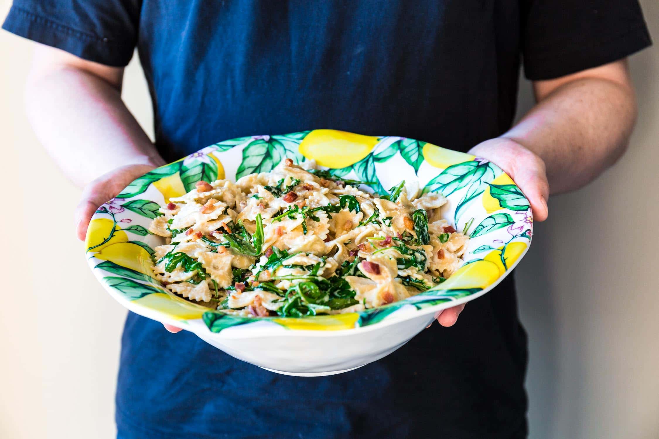 Farfalle with Pancetta, Arugula and Lemon Cream Sauce | www.oliviascuisine.com | A pasta dish that embodies all the things we love about spring and summer. Fresh, colorful and tied together with a lip smacking lemon cream sauce that is to die for! Featuring the beautiful Q Squared NYC's Limonata Collection. (Recipe by @oliviascuisine.)