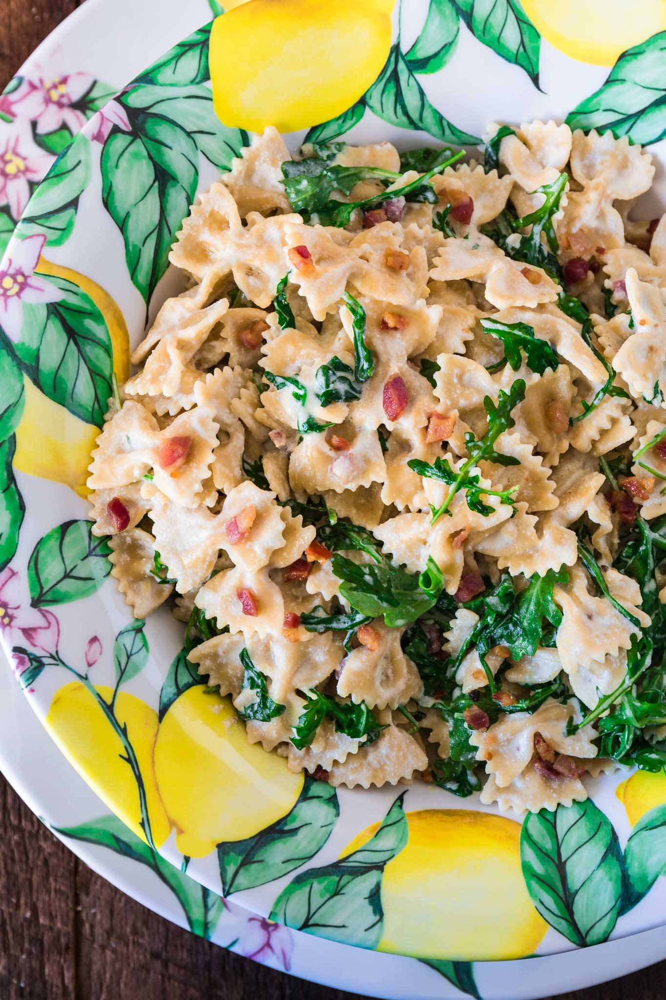 Farfalle with Pancetta, Arugula and Lemon Cream Sauce | www.oliviascuisine.com | A pasta dish that embodies all the things we love about spring and summer. Fresh, colorful and tied together with a lip smacking lemon cream sauce that is to die for! Featuring the beautiful Q Squared NYC's Limonata Collection. (Recipe by @oliviascuisine.)