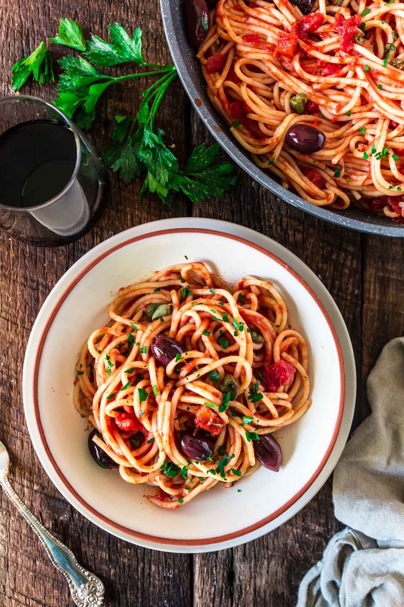 Spaghetti alla Puttanesca | www.oliviascuisine.com | Spaghetti alla Puttanesca is an Italian classic and a specialty of the Campania region. Consisting of tomatoes, garlic, olives, capers and anchovies (which are optional in my version), this dish is quick, deliciously aromatic and on the table in 20 minutes! (Recipe by @oliviascuisine.)