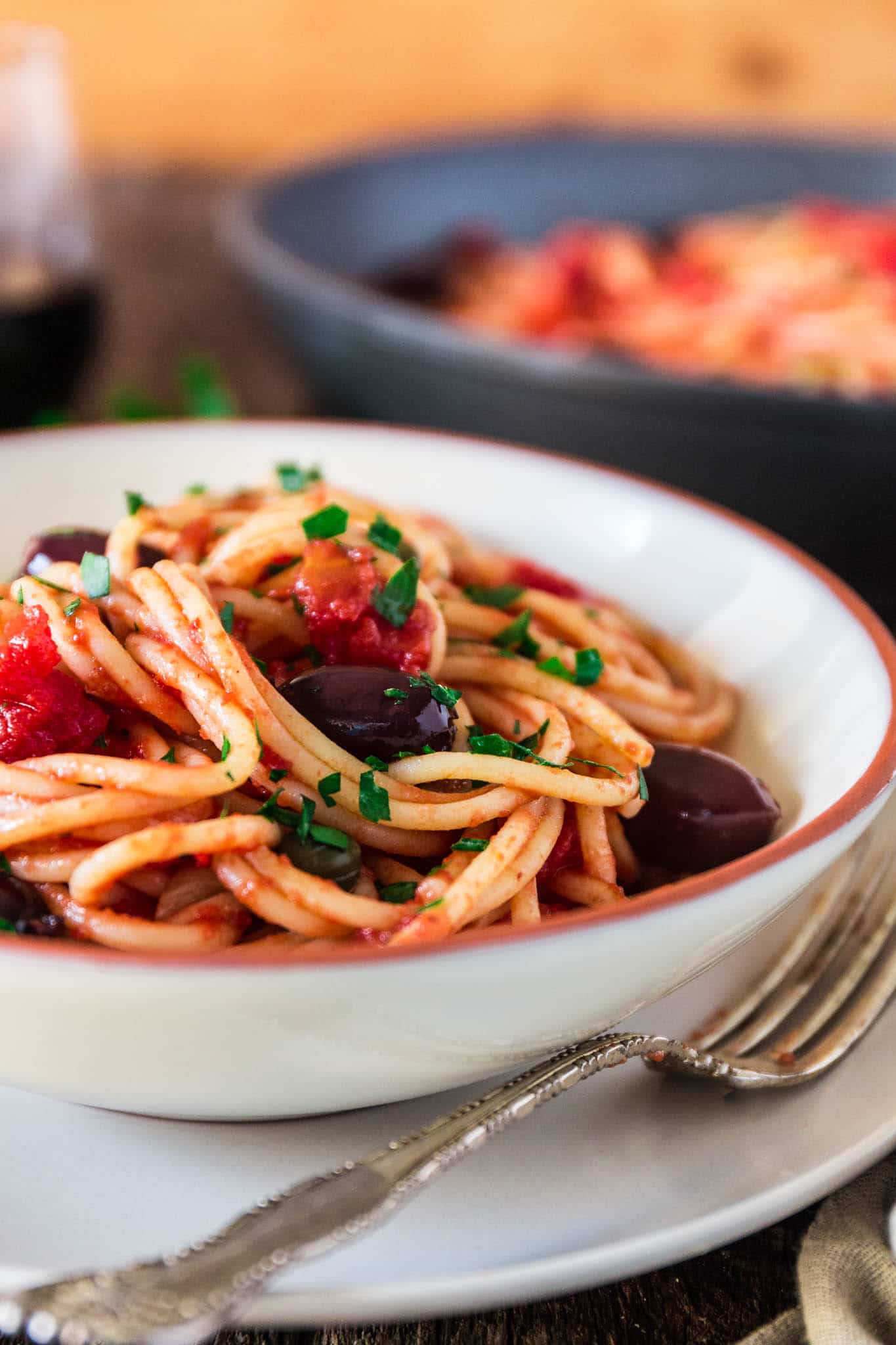 Spaghetti alla Puttanesca | www.oliviascuisine.com | Spaghetti alla Puttanesca is an Italian classic and a specialty of the Campania region. Consisting of tomatoes, garlic, olives, capers and anchovies (which are optional in my version), this dish is quick, deliciously aromatic and on the table in 20 minutes! (Recipe by @oliviascuisine.)