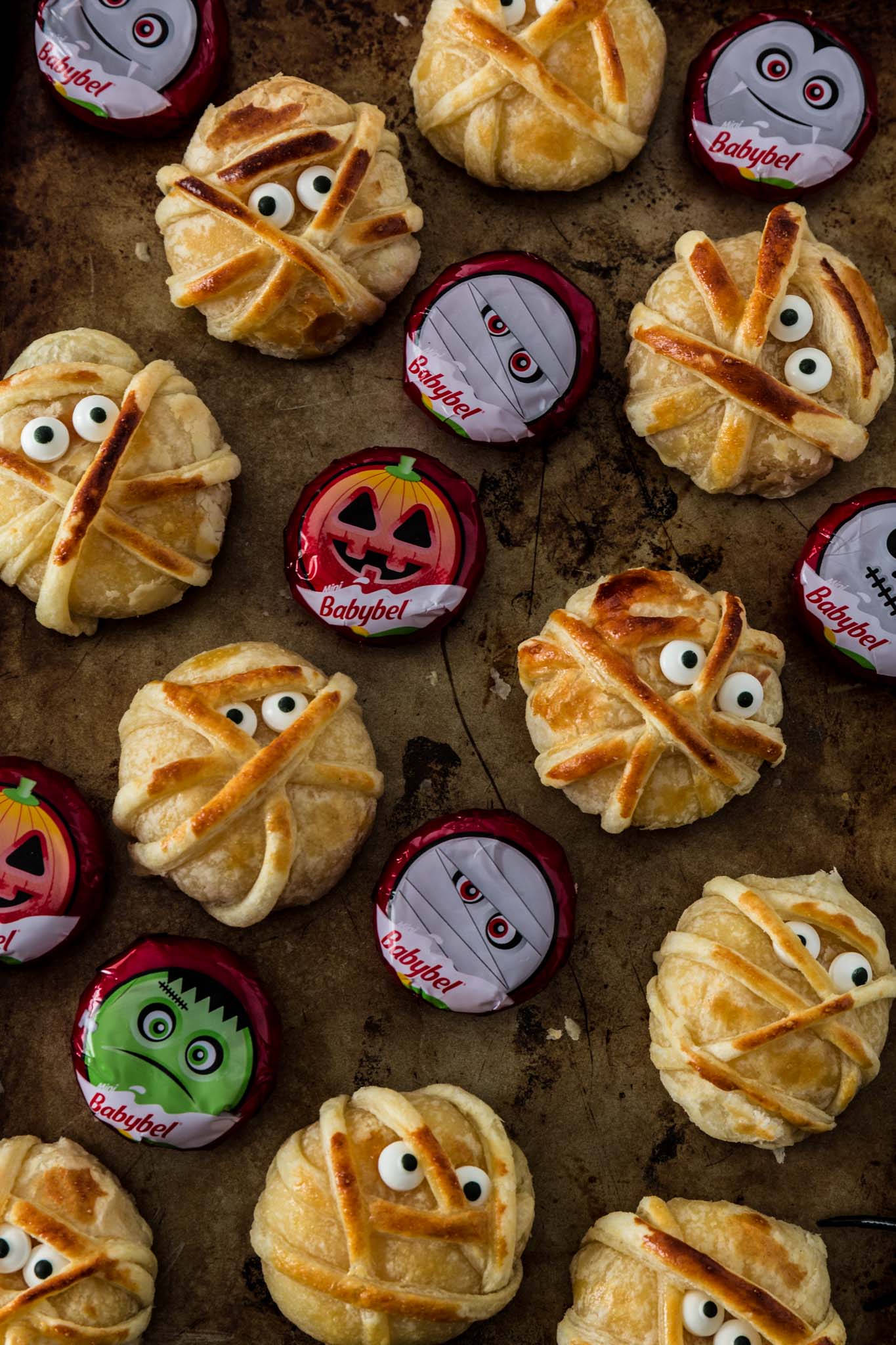 Baked Cheese Mummies | www.oliviascuisine.com | These fun puff pastry wrapped cheese mummies are not only cheesy-licious but very easy to make! They are sure to be the hit of your Halloween party! (Recipe and food photography by @oliviascuisine.)