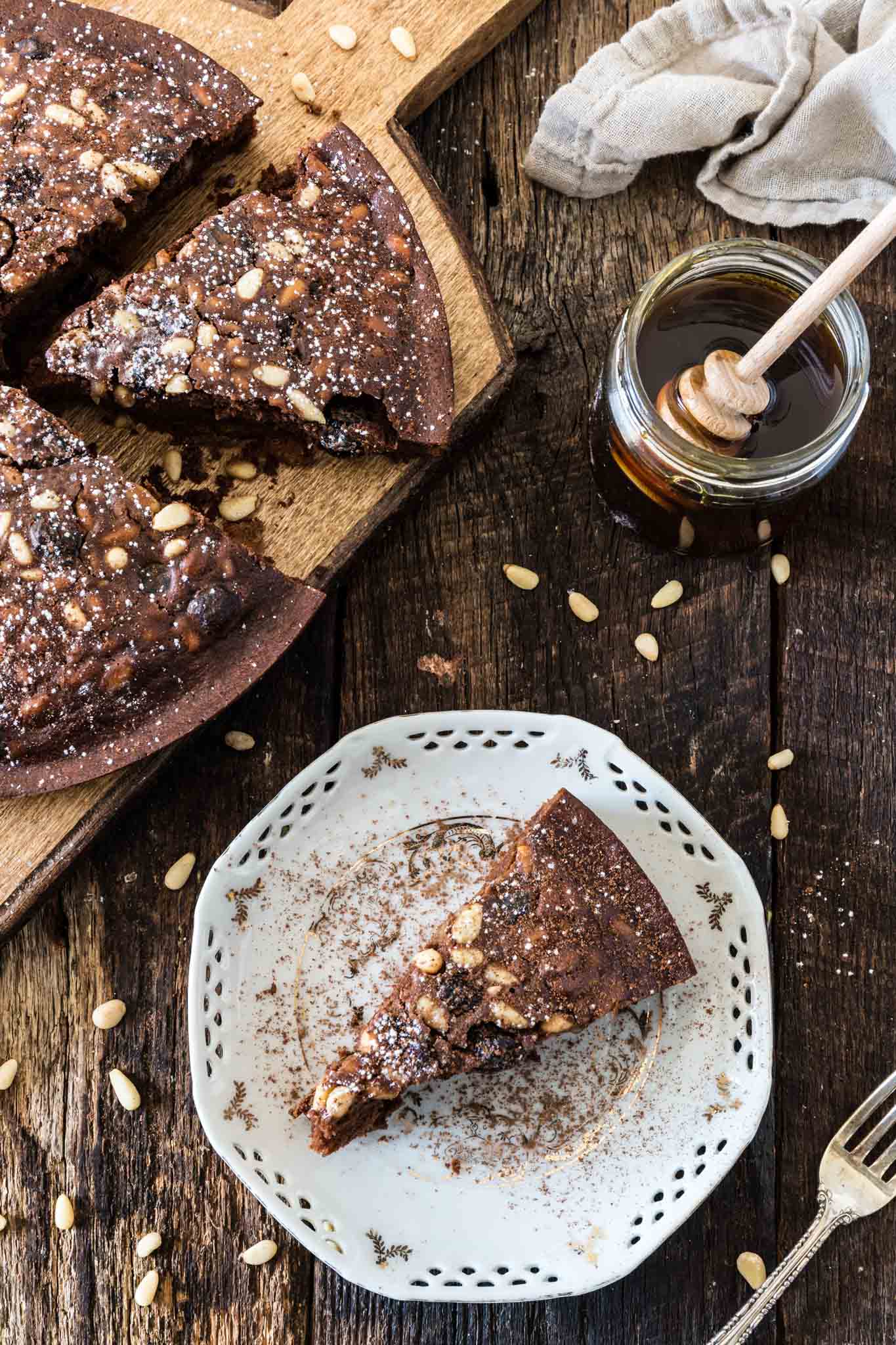 Castagnaccio Pugliese (Chestnut Flour Cake) | www.oliviascuisine.com | An Italian autumnal classic, the Castagnaccio is a gluten-free cake made of chestnut flour, olive oil, dried fruits and nuts. Served with a cup of espresso (or wine) and a drizzle of honey, it is the perfect treat on a cold afternoon.