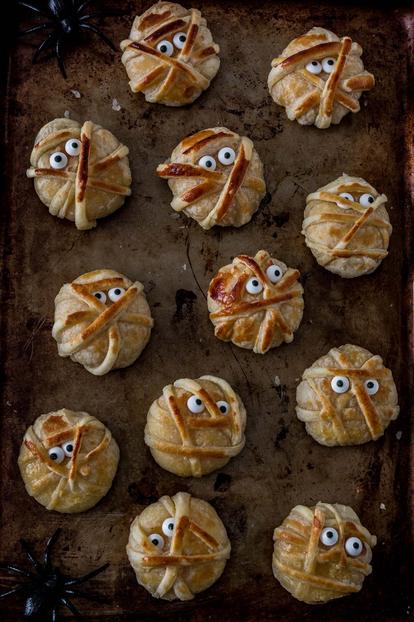 Baked Cheese Mummies | www.oliviascuisine.com | These fun puff pastry wrapped cheese mummies are not only cheesy-licious but very easy to make! They are sure to be the hit of your Halloween party! (Recipe and food photography by @oliviascuisine.)