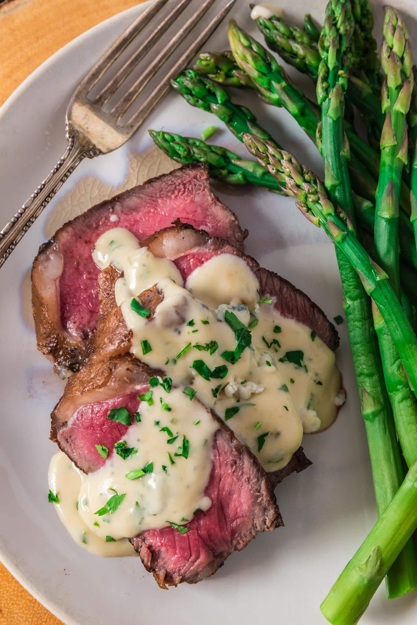 Pan Seared New York Strip Steak with Gorgonzola Sauce | www.oliviascuisine.com | No need to go to a steakhouse to enjoy a juicy New York Strip Steak, cooked to perfection. Follow my tips and you can make a superb steak dinner right at home, on your stove, in less than 30 minutes! The buttery Gorgonzola Cream Sauce is optional, but you'd be crazy to skip it. (Recipe and food photography by @oliviascuisine.)