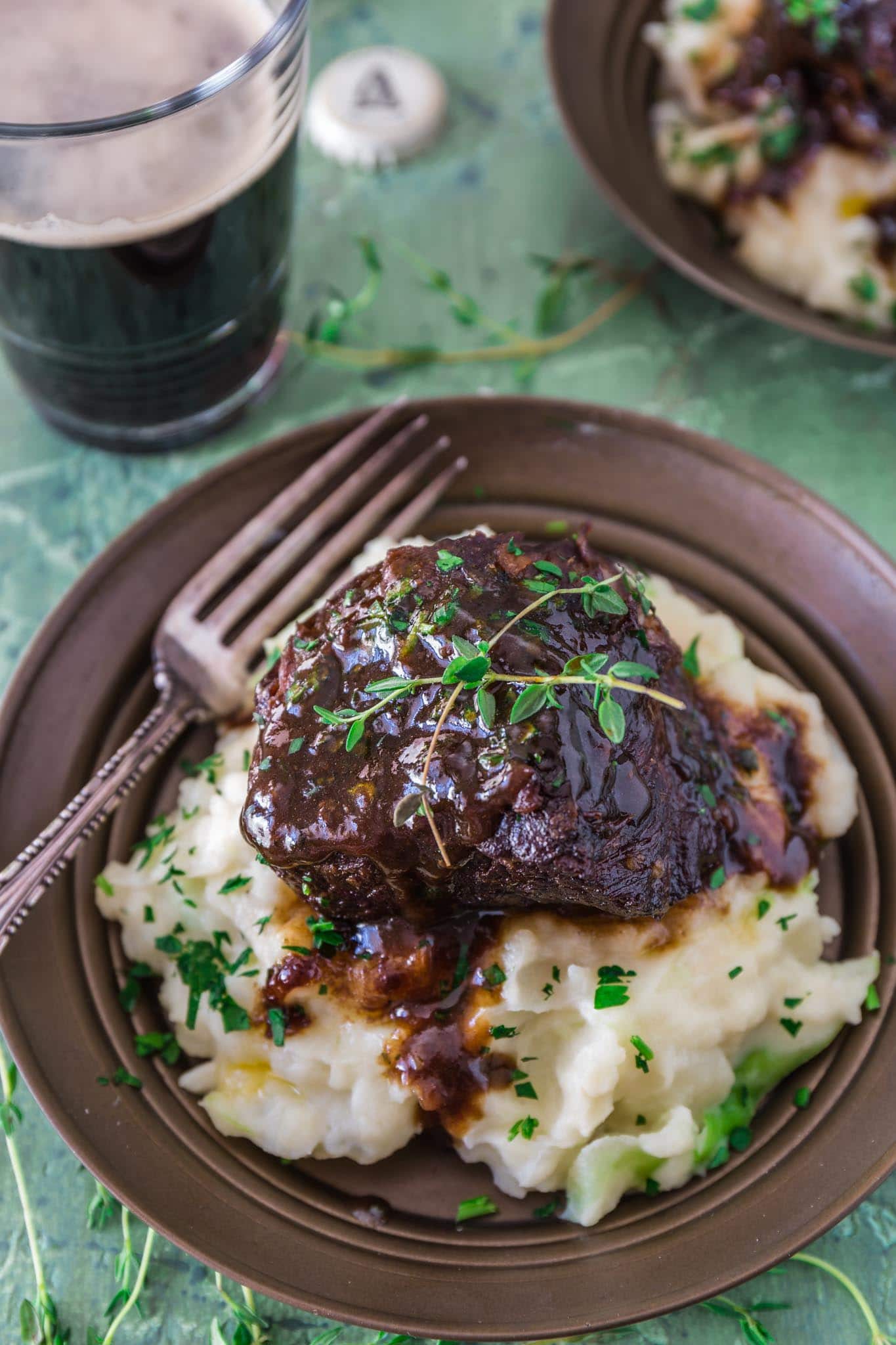 Stout Beer Braised Short Ribs | www.oliviascuisine.com | Celebrate St. Patrick's Day by cooking these Irish inspired Stout Beer Braised Short Ribs. Rich, hearty and incredibly fall-apart tender! Serve it over colcannon or with some Irish soda bread to soak up all that luscious beer gravy goodness. (Recipe and food photography by @oliviascuisine.)
