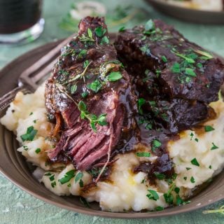 Stout Beer Braised Short Ribs | www.oliviascuisine.com | Celebrate St. Patrick's Day by cooking these Irish inspired Stout Beer Braised Short Ribs. Rich, hearty and incredibly fall-apart tender! Serve it over colcannon or with some Irish soda bread to soak up all that luscious beer gravy goodness. (Recipe and food photography by @oliviascuisine.)
