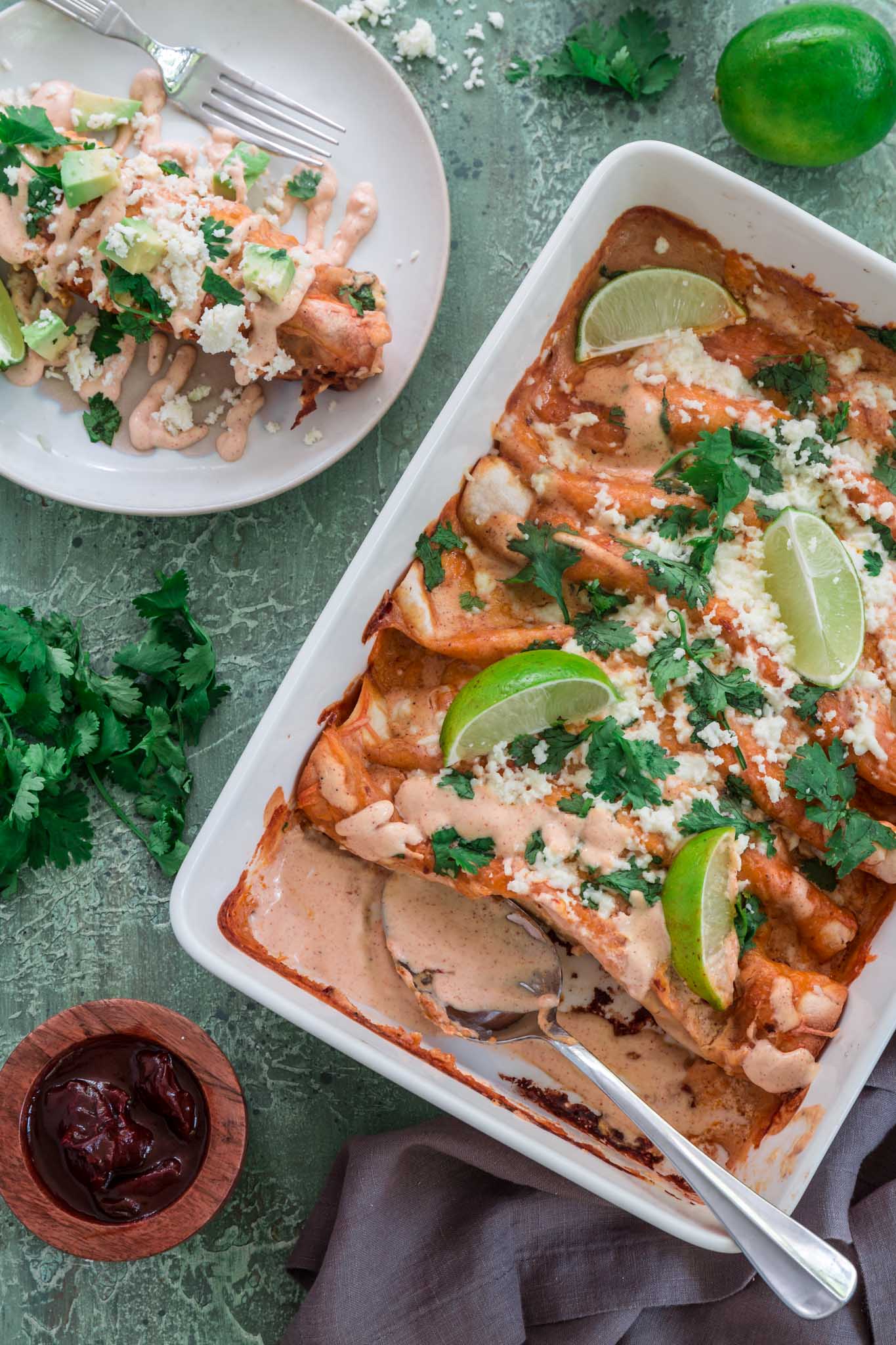 Chicken and Chorizo Enchiladas with Chipotle Crema Sauce | www.oliviascuisine.com | If you like it hot, these Chicken and Chorizo Enchiladas are for you! Spicy, delicious, and smothered with the creamiest Chipotle Crema Sauce. They will knock your socks off! (Recipe and food photography by @oliviascuisine.)