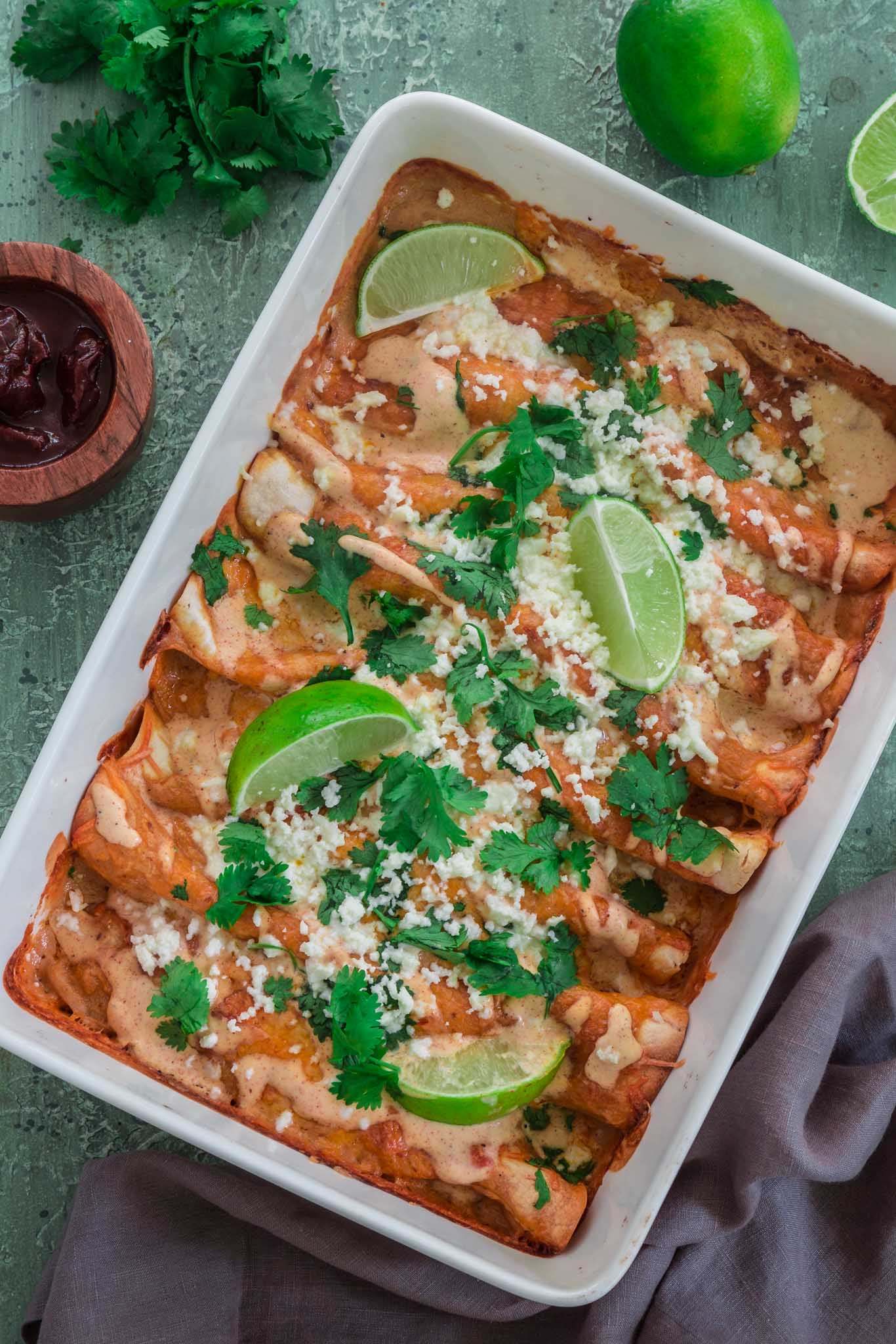 Chicken and Chorizo Enchiladas with Chipotle Crema Sauce | www.oliviascuisine.com | If you like it hot, these Chicken and Chorizo Enchiladas are for you! Spicy, delicious, and smothered with the creamiest Chipotle Crema Sauce. They will knock your socks off! (Recipe and food photography by @oliviascuisine.)