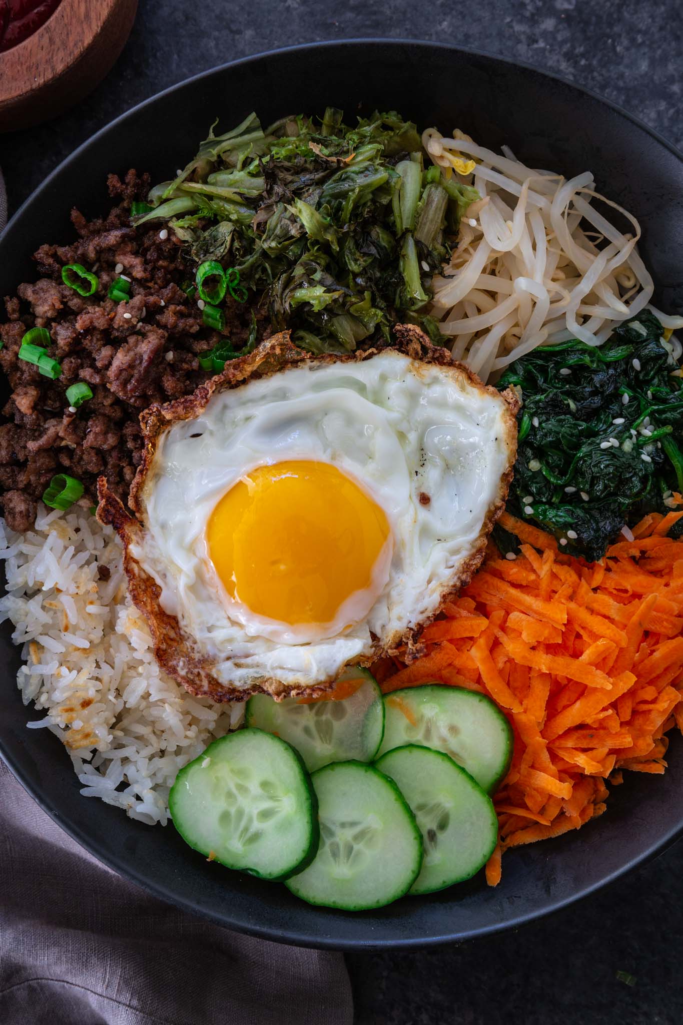 Bibimbap (Korean Beef Rice Bowl) | www.oliviascuisine.com | My version of Bibimbap, a popular Korean rice dish, takes a few shortcuts for convenience! The good news is that it’s done in less than 30 minutes without compromising flavor. Serve with a fried egg on top for that extra wow factor! (Recipe and food photography by @oliviascuisine.)