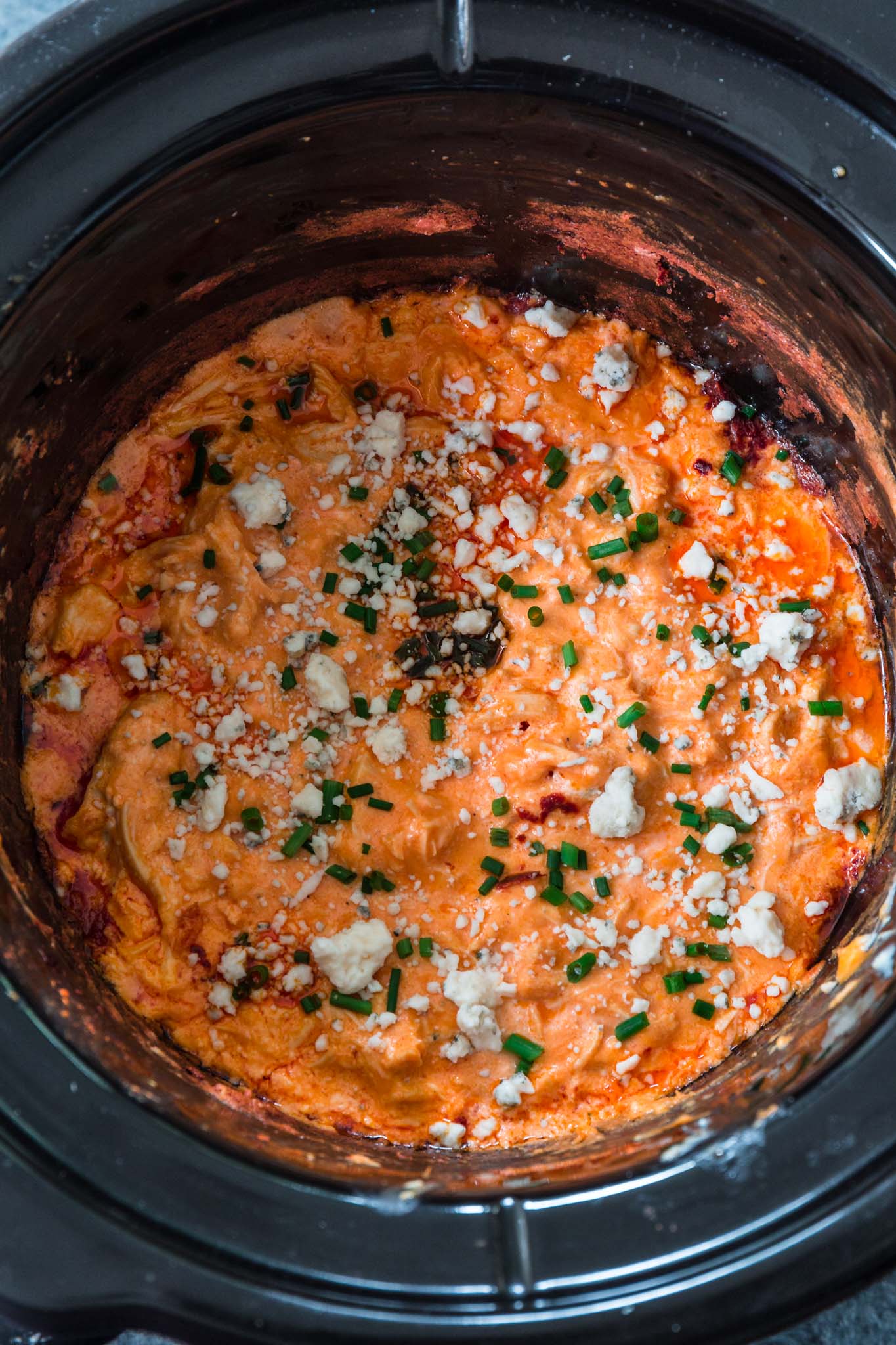 Slow Cooker Buffalo Chicken Dip | www.oliviascuisine.com | Get ready for football season with this easy and delicious Buffalo Chicken Dip! Made in the slow cooker and served hot with your favorite topping and tortilla chips. What could be better than that? (Recipe and food photography by @oliviascuisine.)