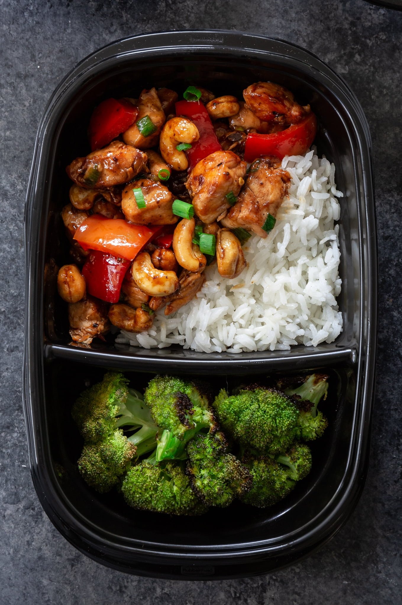 Meal Prep Cashew Chicken | www.oliviascuisine.com | Who needs takeout when you can cook delicious Cashew Chicken at home? Tender chicken, scallions and peppers coated in a rich, sweet sauce and topped with crunchy cashews. I can't get enough of it! (Recipe and food photography by @oliviascuisine.)