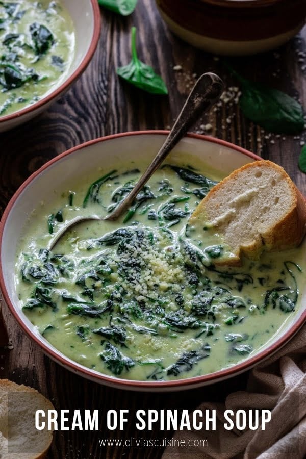 a bowl of cream of spinach soup served with a bread slice