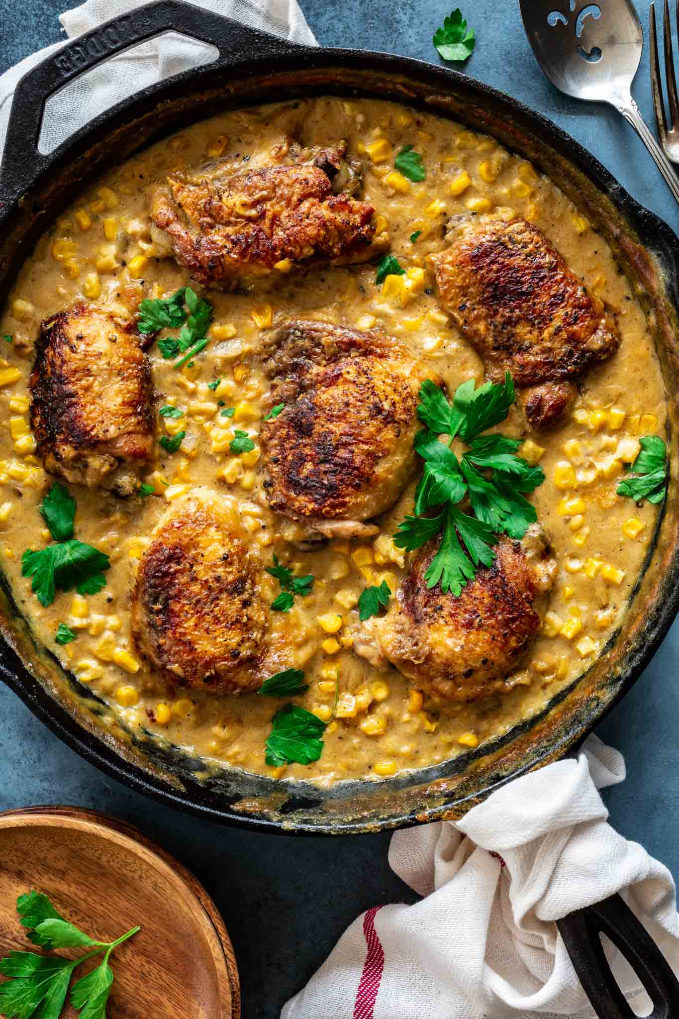 Chicken thighs nested on a bed of delicious creamed corn