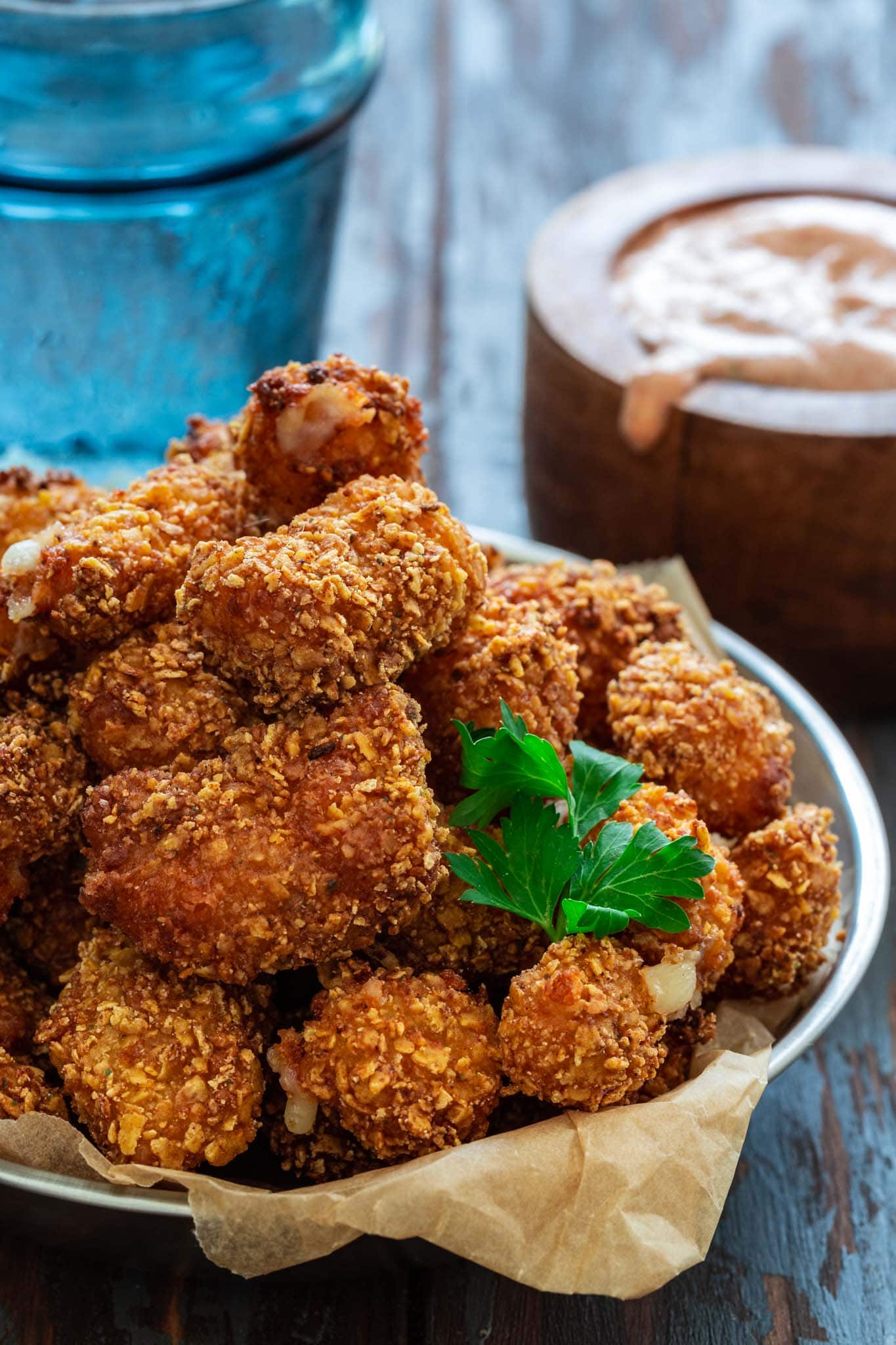 A plate of fried cheese curds with dipping sauce