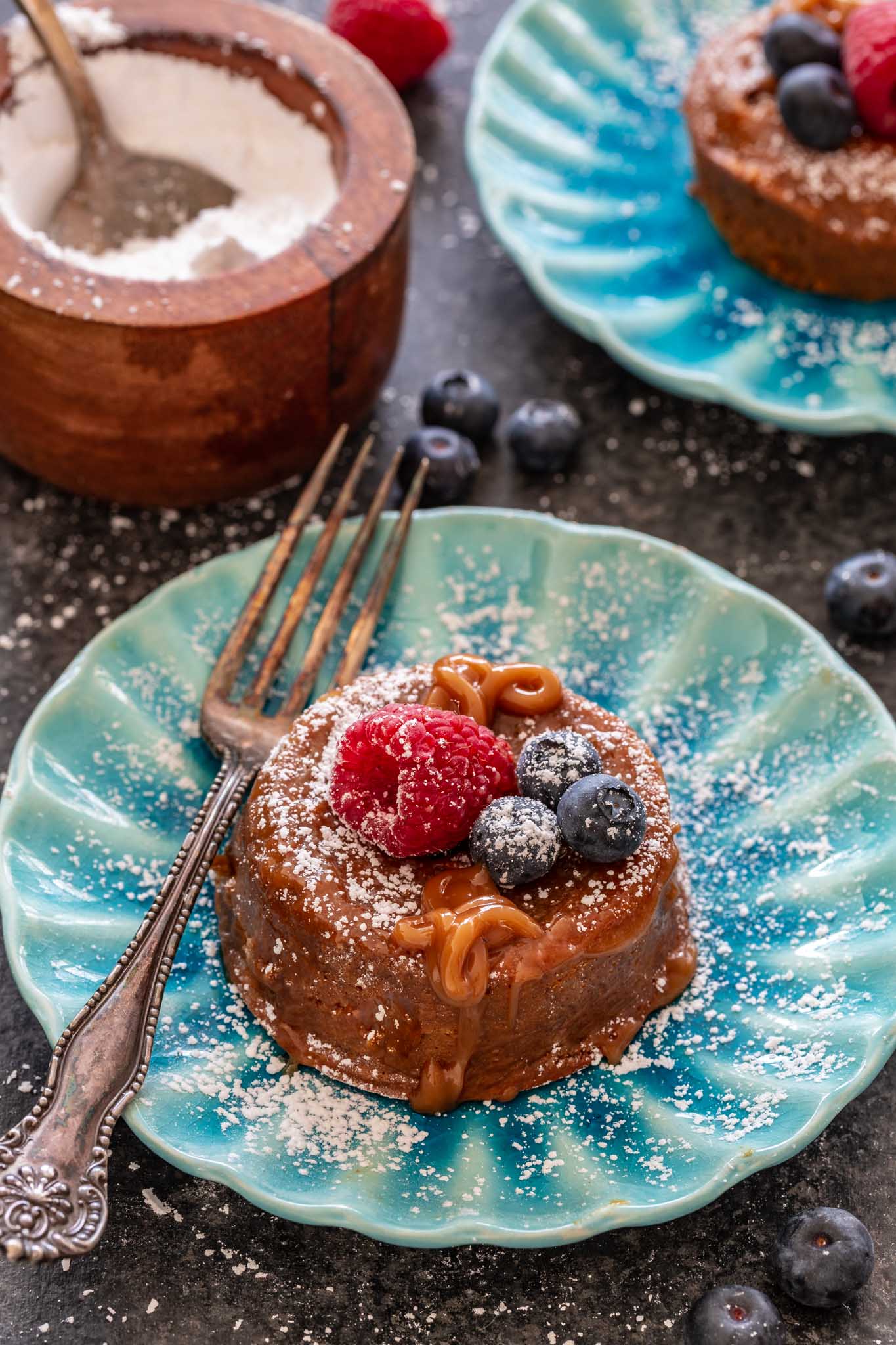 Molten Dulce de Leche Cakes topped with berries.